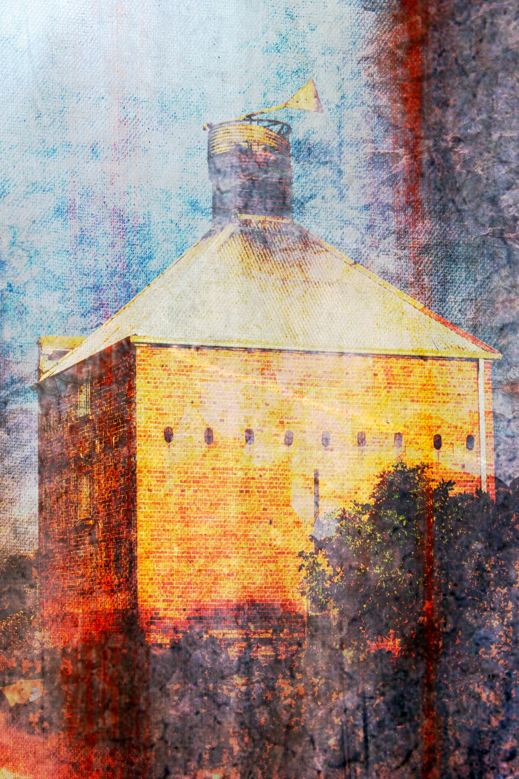 A textured study of a weathered brick building topped with a vane beneath a pale sky.