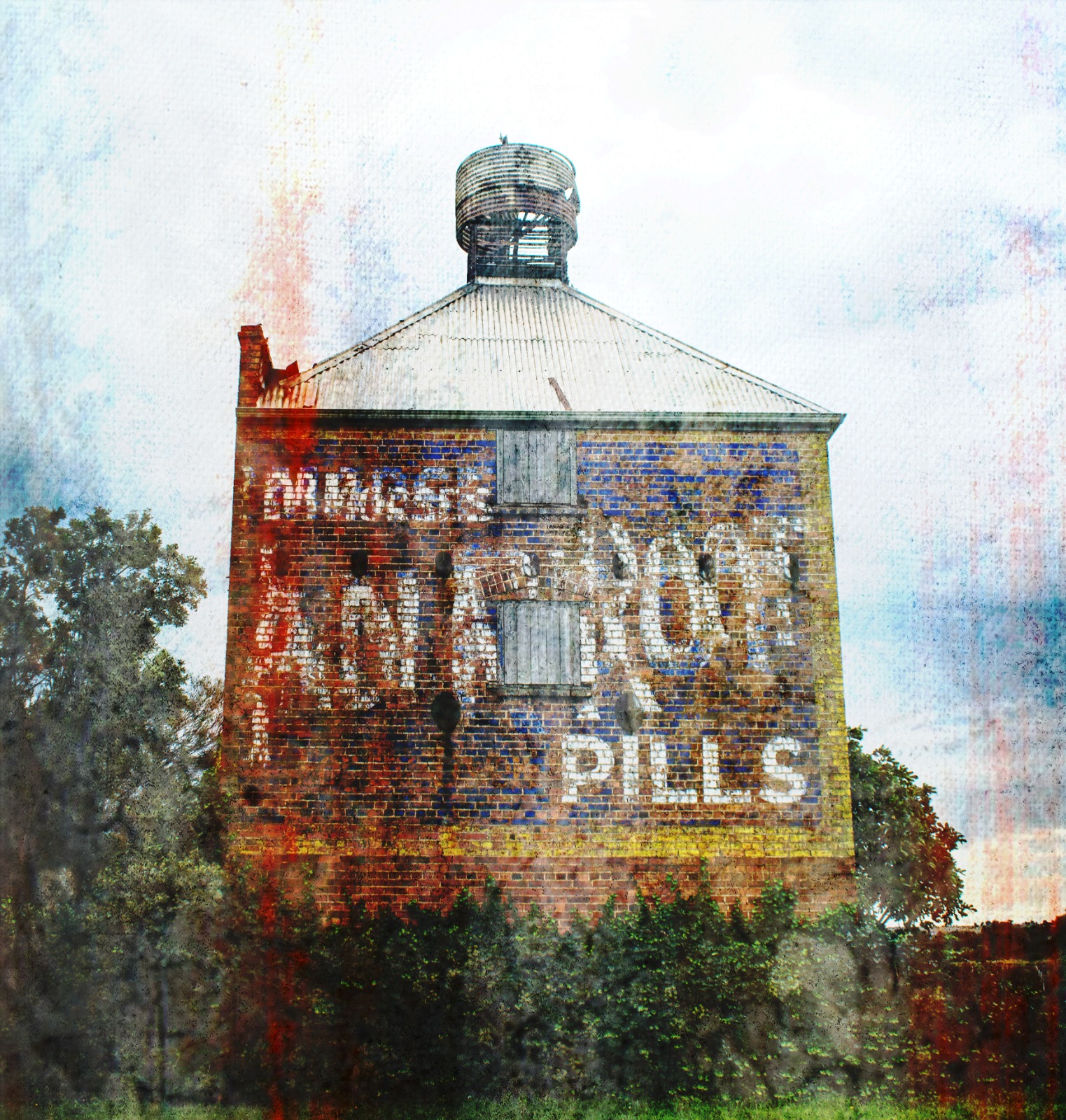 A brick industrial-style building carrying a faded painted advertisement across its wall.